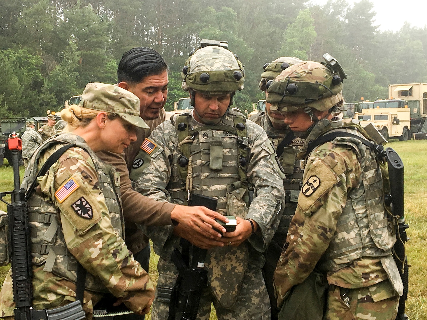 Oscar Hernandez, second from lef), a training specialist from the U.S. Army Space and Missile Defense Agency, guides Ohio Army National Guard Soldiers from the 1487th Transportation Company on how to detect electromagnetic interference on an AN/PSN-13 Defense Advanced GPS Receiver (DAGR) June 23, 2018, during annual training at Camp Grayling Joint Maneuver Training Center in Grayling, Mich. This training provides Soldiers guidance in the event they encounter a contested electronic warfare environment.