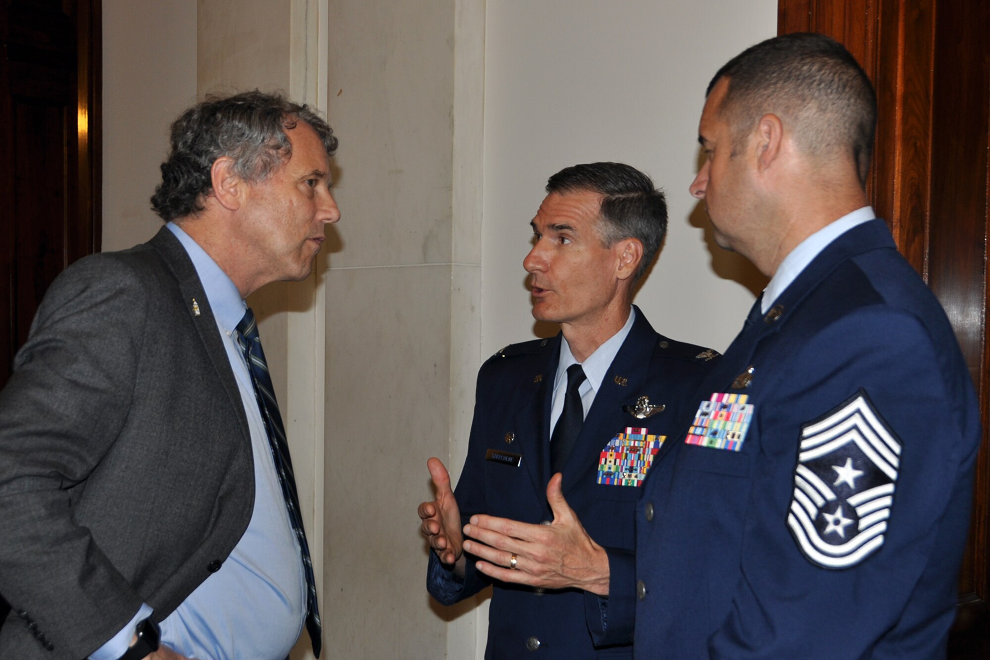 Air Force Reserve 910th Airlift Wing Commander Col. Dan Sarachene (center), based at Youngstown Air Reserve Station, Ohio, talks with Ohio Senator Sherrod Brown, as 910th Airlift Wing Command Chief Master Sgt. Bob Potts listens, during a meeting on Capitol Hill here, June 21, 2018.