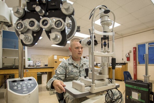 U.S. Air Force Tech. Sgt. Eric Low, a medical technician from the New Hampshire Air National Guard’s 157th Air Refueling Wing, inspects optometry equipment for a health-care clinic at Lee County High School in Beattyville, Ky., June 14, 2018. The clinic is one of four being staffed by military health-care professionals in Eastern Kentucky from June 15 to June 24 as part of an Innovative Readiness Training mission called Operation Bobcat. The mission provides military forces with crucial expeditionary training while offering no-cost medical, dental and optometry care to area residents. (Air National Guard photo by Lt. Col. Dale Greer)