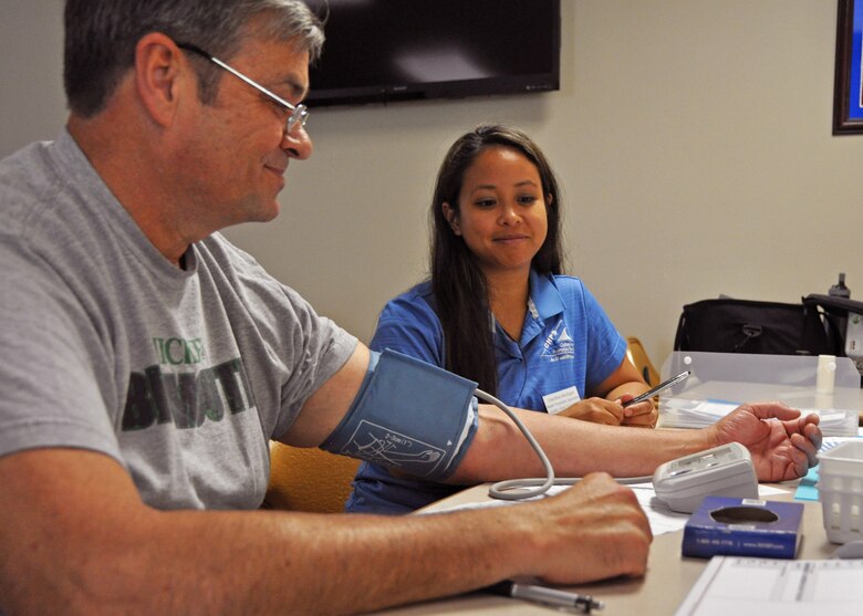 Cleoflins Mulligan, a health promotion specialist from Eglin Air Force Base’s Civilian Health Promotions Services Program, checks a participant’s blood pressure during their health fair June 27, 2018 at Duke Field, Fla.