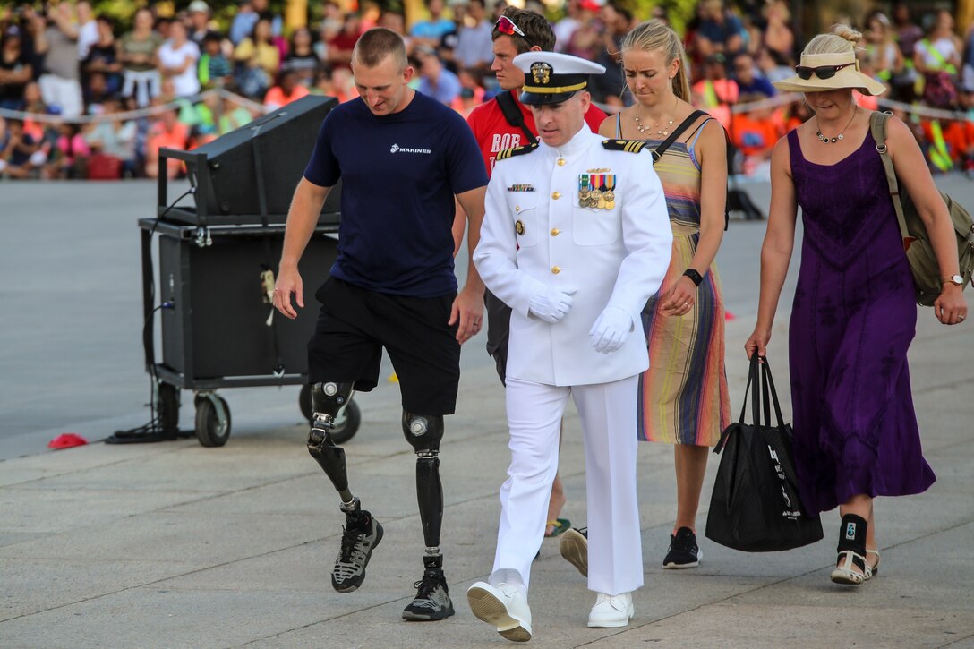 Marine veteran and Paralympian, Robert Jones, is escorted to the reviewing area by LCDR Jason Duff, clinical psychologist, Marine Barracks Washington D.C., during a Tuesday Sunset Parade at the Lincoln Memorial, Washington D.C., June 26, 2018. The guest of honor for the parade was the Honorable William McClellan Thornberry, Texas’ 13th Congressional District Congressman, and the hosting official was Lt. Gen. Steven R. Rudder, deputy commandant, aviation, headquarters Marine Corps. (Official U.S. Marine Corps photo by Cpl. Damon Mclean/Released)
