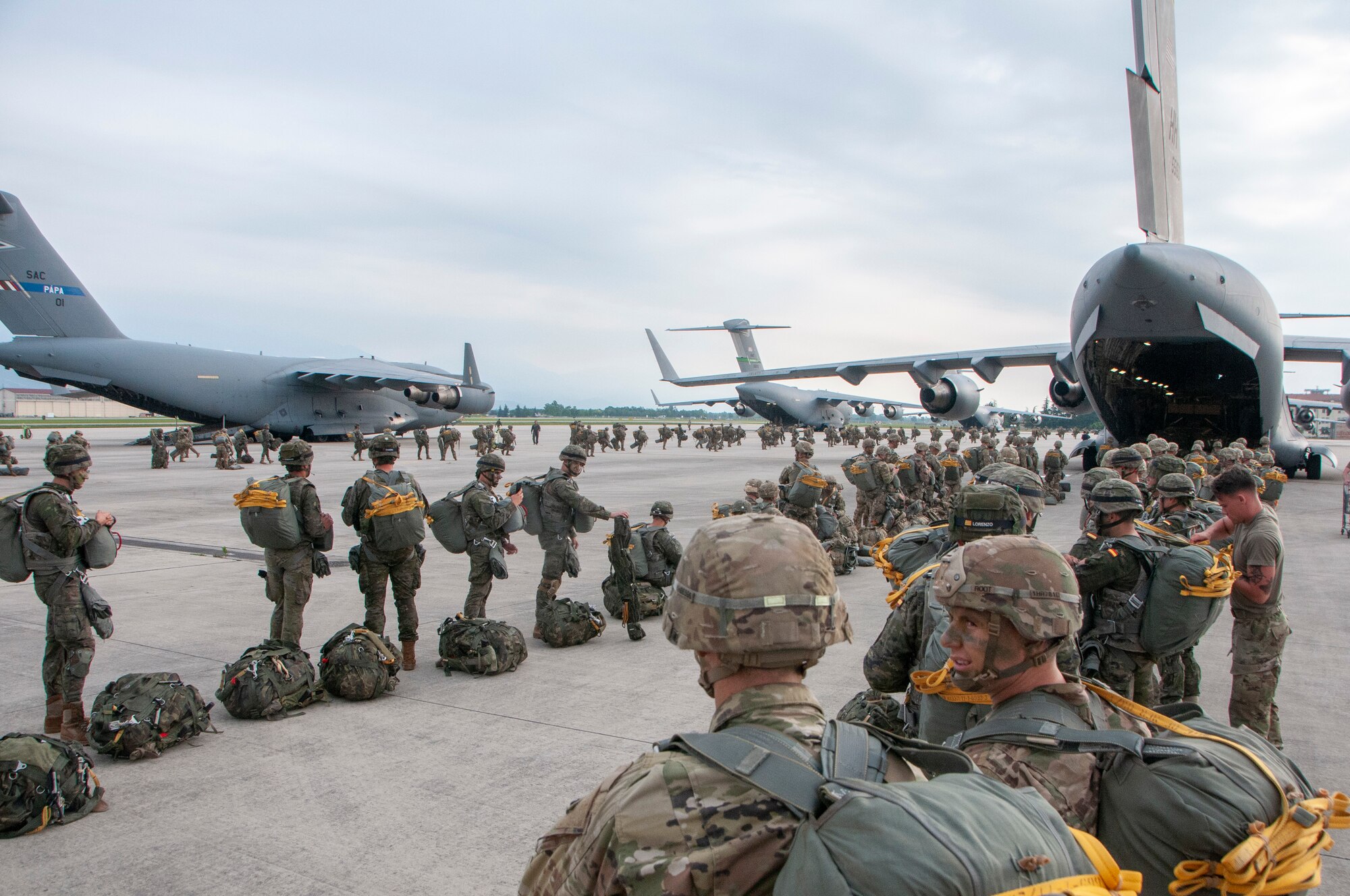 Members of the U.S. Army 1st Battalion, 503rd Infantry Regiment, 173rd Airborne Brigade and Spanish Army Airborne Brigade prepare to board a C-17 Globemaster III during exercise Bayonet Strike June 12, 2018, at Aviano Air Base, Italy.
