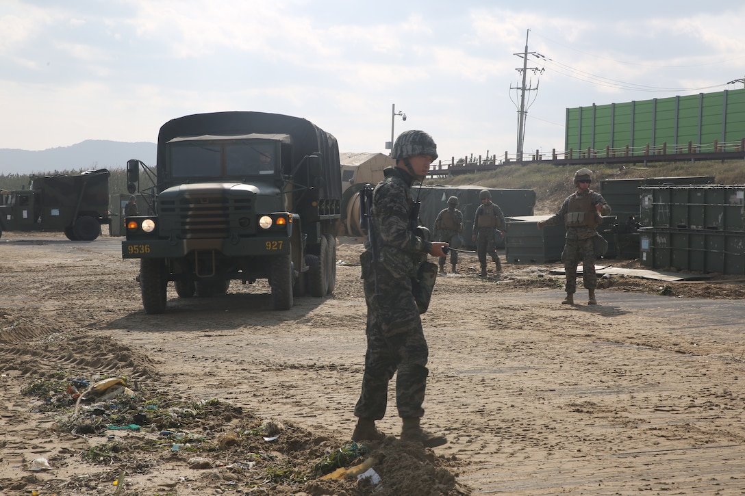 Republic of Korea and U.S. Marines guide tactical vehicles during bilateral convoy operations Oct. 26, 2017 at Dogu Beach, Pohang, South Korea. U.S. Marines with 3d TSB, CLR-3, 3d Marine Logistics Group and ROK Marines with Landing Support Battalion, ROK MLG participated in the bilateral convoy as a part of CLR-3’s Mission Rehearsal Exercise during Exercise Winter Workhorse 17/Korean Marine Exchange Program 18.1. The exercise highlights the two countries’ combined commitment to the defense of the ROK and our shared commitment to peace and security in the region. (U.S. Marine Corps photo by Sgt. Tiffany Edwards)