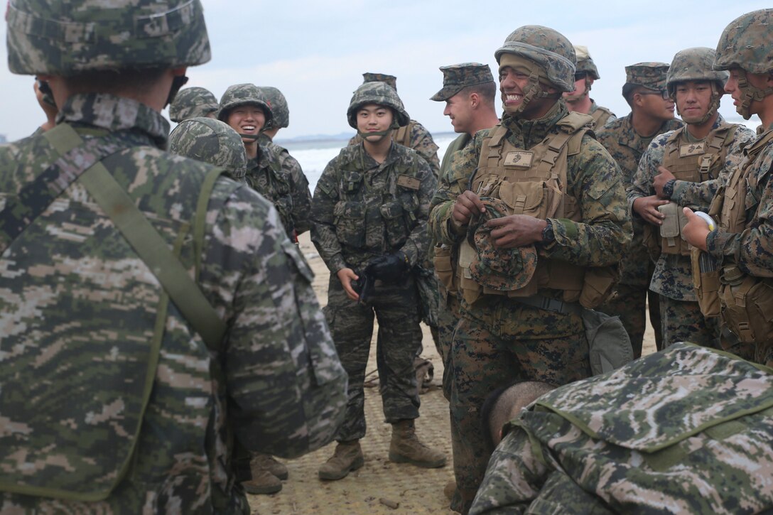 U.S. Marine Lance Cpl. Wilber Valencia, a water purification specialist with Bulk Fuels Company, 9th Engineer Support Battalion, Combat Logistics Regiment 3, 3d Marine Logistics Group, laughs with Republic of Korea Marines during a Mission Rehearsal Exercise (MRX) Oct. 26, 2017 at Dogu Beach, Pohang, South Korea. U.S. Marines with CLR-3, 3d MLG and ROK Marines with Landing Support Battalion, ROK MLG participated in the MRX during Exercise Winter Workhorse 17/Korean Marine Exchange Program 18.1. The individual Marines and Sailors’ relationships with their ROK counterparts are the strength of III MEF in the Pacific. (U.S. Marine Corps photo by Sgt. Tiffany Edwards)