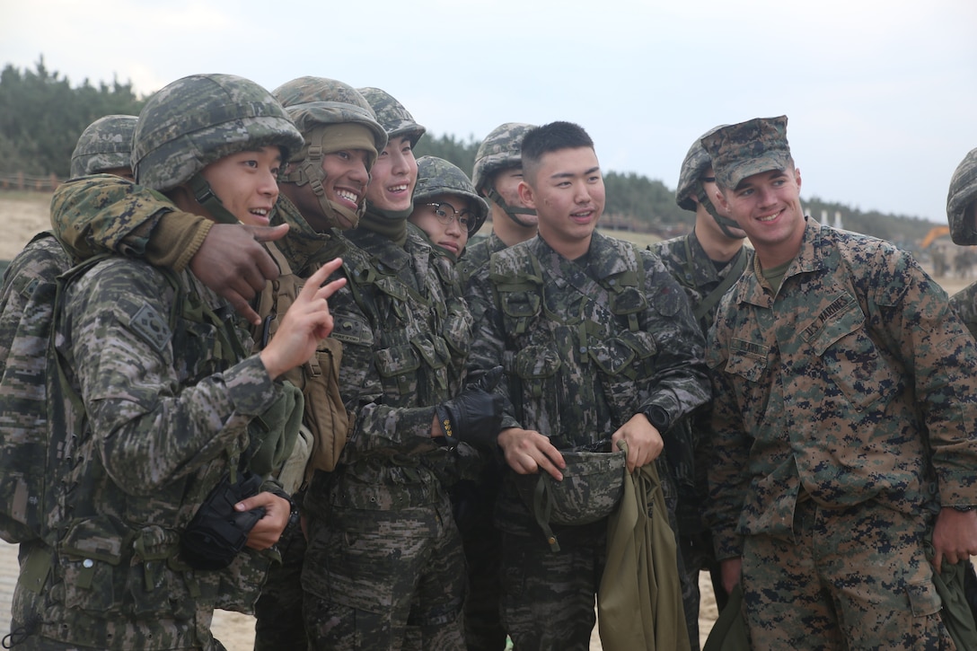 U.S. Marine Lance Cpl. Wilber Valencia, a water purification specialist with Bulk Fuels Company, 9th Engineer Support Battalion, Combat Logistics Regiment 3, 3d Marine Logistics Group, takes pictures with Republic of Korea Marines after a Mission Rehearsal Exercise (MRX) Oct. 26, 2017 at Dogu Beach, Pohang, South Korea. U.S. Marines with CLR-3, 3d MLG and ROK Marines with Landing Support Battalion, ROK MLG participated in the MRX during Exercise Winter Workhorse 17/Korean Marine Exchange Program 18.1. The individual Marines and Sailors’ relationships with their ROK counterparts are the strength of III MEF in the Pacific. (U.S. Marine Corps photo by Sgt. Tiffany Edwards)