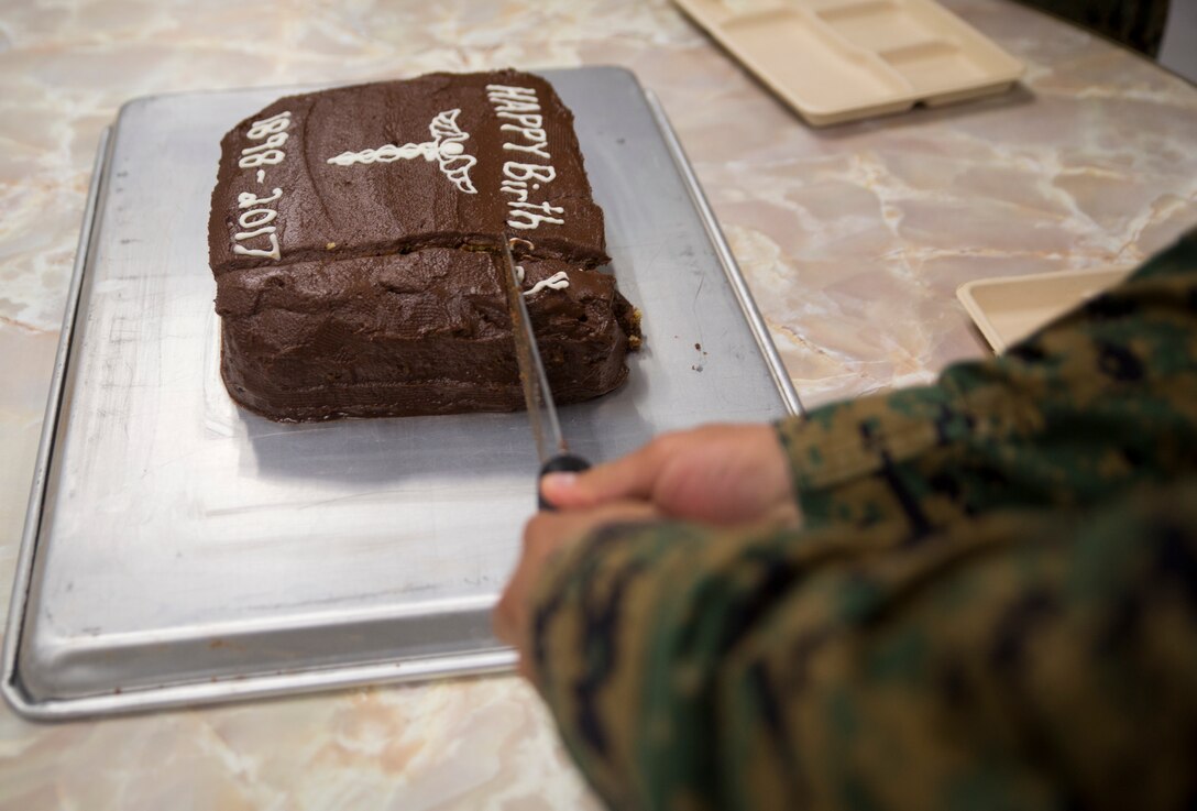 Chief Hospital Corpsman (Fleet Marine Force) Edgar E. Cuenca, a preventive medicine technician with Command Element, III Marine Expeditionary Force, cut a ceremonial cake into squares during a celebration for the 119th birthday of the hospital corpsman rate at Camp Mujuk, Pohang, Republic of Korea, June 17, 2017. Marines from Bravo Company, 3rd Law Enforcement Battalion, III Marine Headquarters Group, III MEF and Corpsmen with 3rd Medical Battaion, 3rd Marine Logistics Group, III MEF came together to celebrate the birthday with a ceremonial cake cutting and birthday message reading from 3rd LE Bn senior enlisted advisor 1st Sgt. Derrick Benbow. (U.S. Marine Corps photo by Lance Cpl. Andy Martinez)