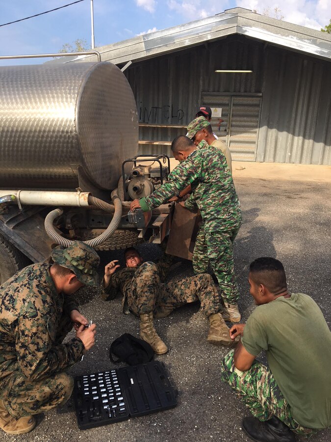 U.S. Marine Lance Cpl. Taylor J. Bolzer and Cpl. Trevor O. Garvin show Timor Leste Falintil Defence Force (F-FDTL) soldiers how to fix water pumps on trucks to prepare for future operations during Harii Hamutuk 17 at Metinaro Military Base, Timor-Leste, Oct. 31, 2017. The U.S. Navy and Marine Corps team conduct exercises regularly with Timor-Leste to maintain a strong working relationship. Bolzer and Garvin are with 9th Engineer Support Battalion, 3d Marine Logistics Group, III Marine Expeditionary Force. (U.S. Marine Corps Courtesy Photo)
