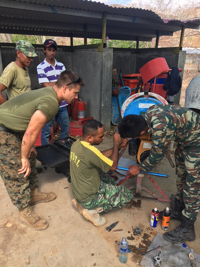 U.S. Marine Lance Cpl Taylor J. Bolzer instructs Timor-Leste Defense Force (F-FDTL) soldiers how to fix cement mixers to prepare for future operations during Exercise Harii Hamutuk 17 at Metinaro Military Base, Timor-Leste, Oct. 23, 2017. The 3d Marine Logistics Group Marines learn and share tactics to become more proficient as the logistics combat element of III Marine Expeditionary Force. Bolzer is with 9th Engineer Support Battalion, 3d MLG, III Marine Expeditionary Force. (U.S. Marine Corps Courtesy Photo)