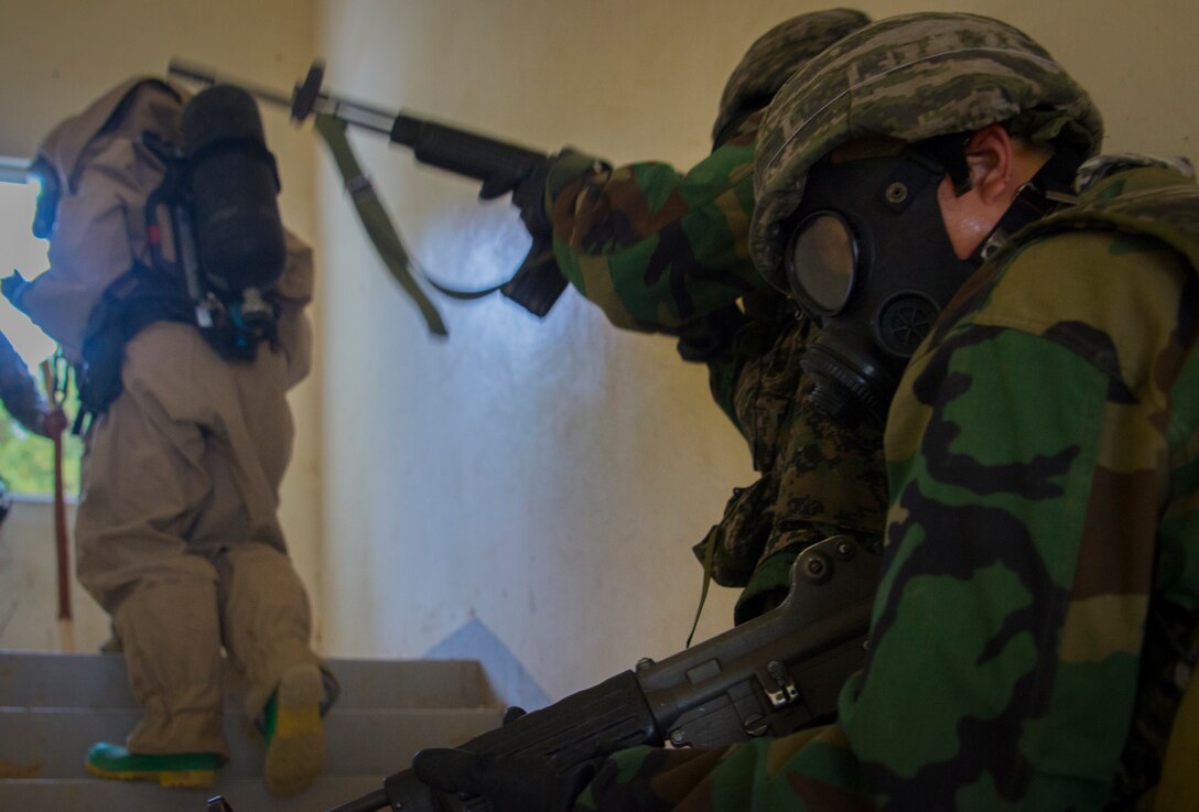 Two Republic of Korea Marines provides security for U.S. chemical, biological, radiological and nuclear defense specialist Marines at Pohang, South Korea, June 30, 2017, during the Korean Marine Exchange Program 17-7. The scenario provided U.S. and ROK Marines with the opportunity to practice skills necessary to detect and identify CBRN threats together. KMEP is a continuous bilateral training exercise that promotes stability on the Korean Peninsula while enhancing the ROK and U.S. alliance. (U.S. Marine Corps photo by Lance Cpl. Andy Martinez)