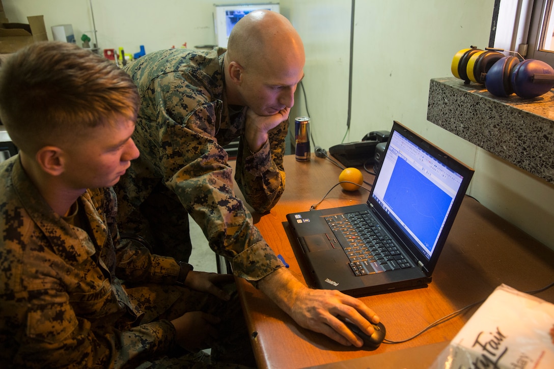 Gunnery Sgt. Justin A. Horn, right, the General Support Maintenance Company metal shop chief and native of Greene, N.Y., and Lance Cpl. Jason Lowes, left, a repair shop machinist and native of Marion, Mich., use software programs to draft their metal work before manufacturing it, Nov. 21, 2017, at Camp Kinser, Okinawa, Japan. Marines at the GSM, 3rd Maintenance Battalion, 3rd Marine Logistics Group, use computer-aided drafting programs that generate and send codes to their machines in order to fabricate hardware.   (U.S. Marine Corps photo by Lance Cpl. Isabella Ortega)