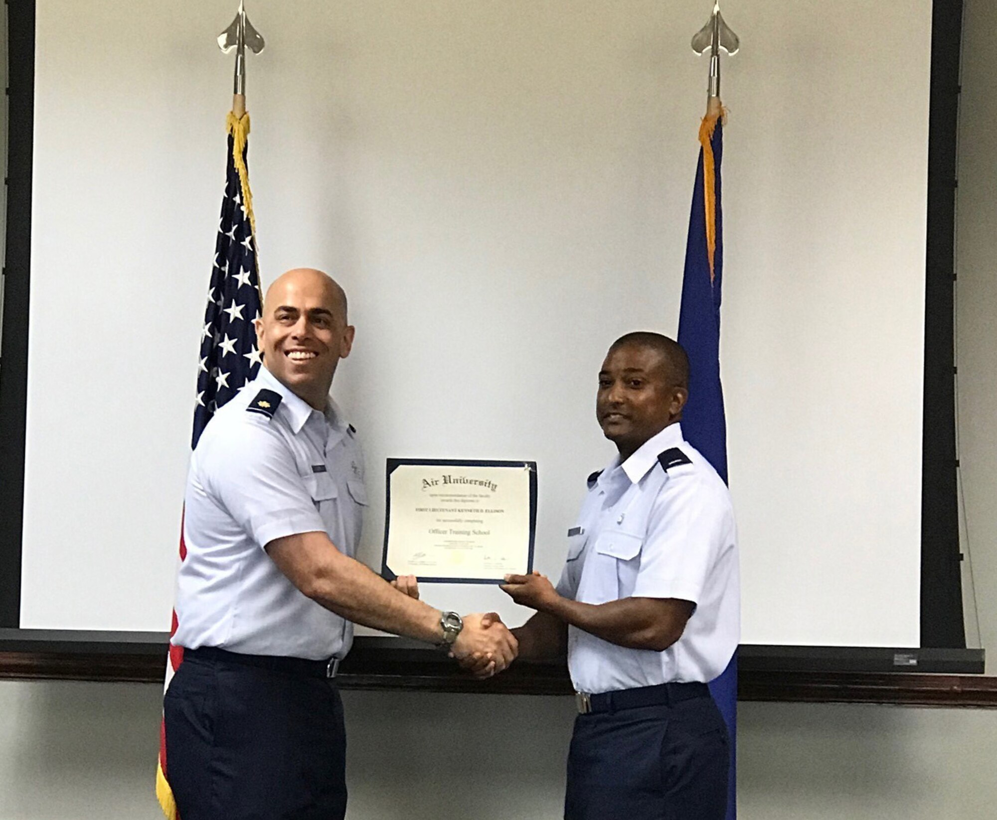 1st Lieutenant Kenneth Ellison receives his diploma from Maj. Francisco Costa upon completion of Commissioned Officer Training Class 18-04, Friday, June 22. Ellison commissioned after 14 years of enlisted service and continues his family’s legacy of continuous Air Force service since his grandfather enlisted in 1947.