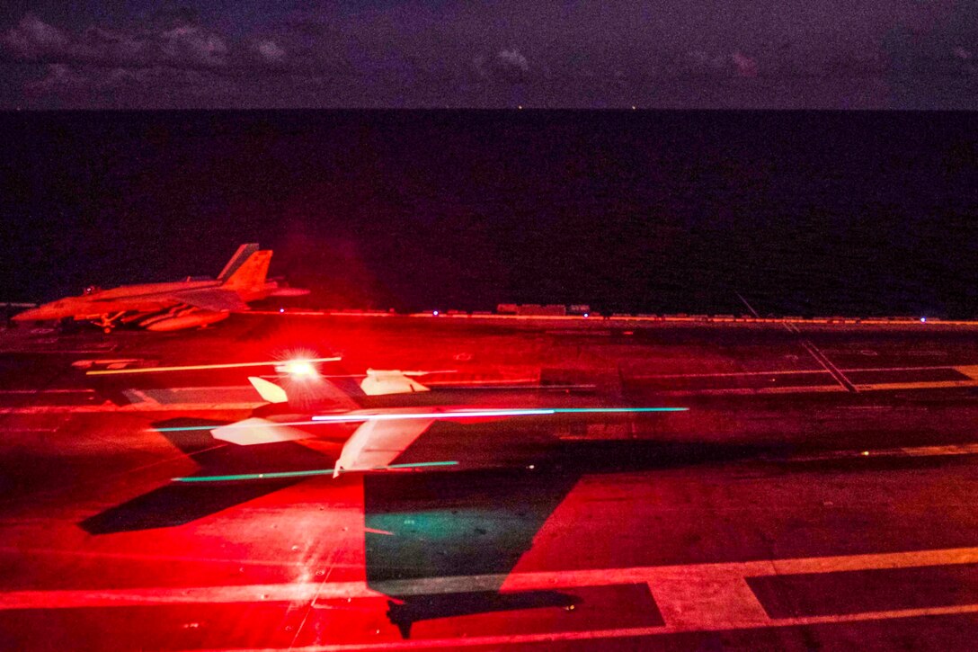 An aircraft takes off from the deck of an aircraft carrier.