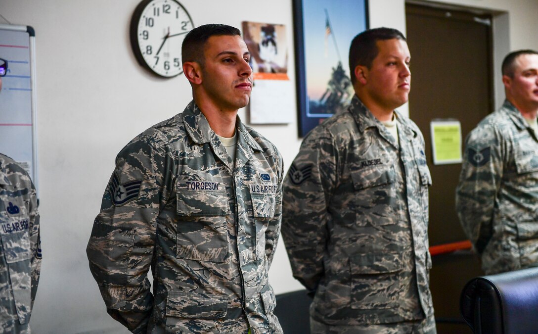 Airmen standing together during a practice board presentation.