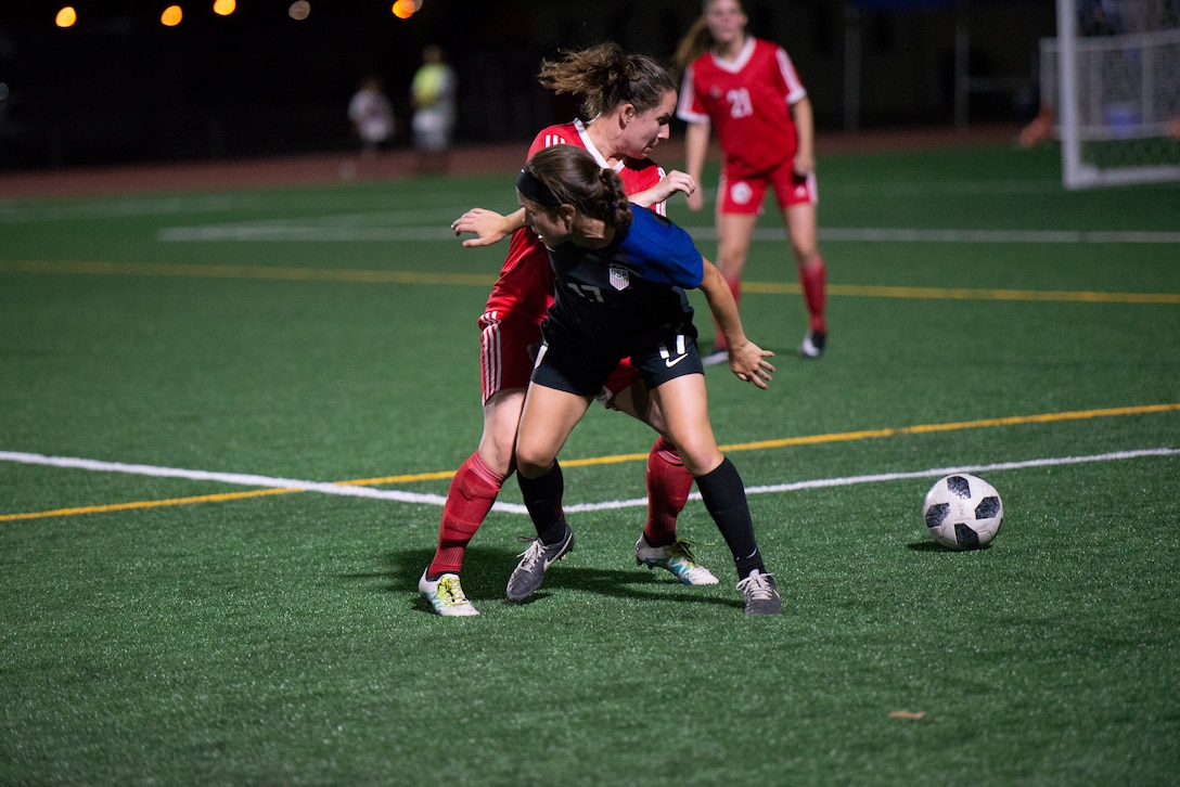 FORT BLISS, Texas. –  Air Force 2nd Lt. Kyele Bridel fights for possession of the ball as the USA team battled Canada June 26 at the 2018 Conseil International du Sport Militaire (CISM) World Military Women’s Football Championship at Fort Bliss’ Stout Field. USA earned their first win of the tournament 1-0 on a penalty kick in the 51st minute. International military teams squared off over 12 days to eventually crown the best women soccer players among the international militaries participating. U.S. Navy photo by Mass Communication Specialist 3rd Class Camille Miller (Released)