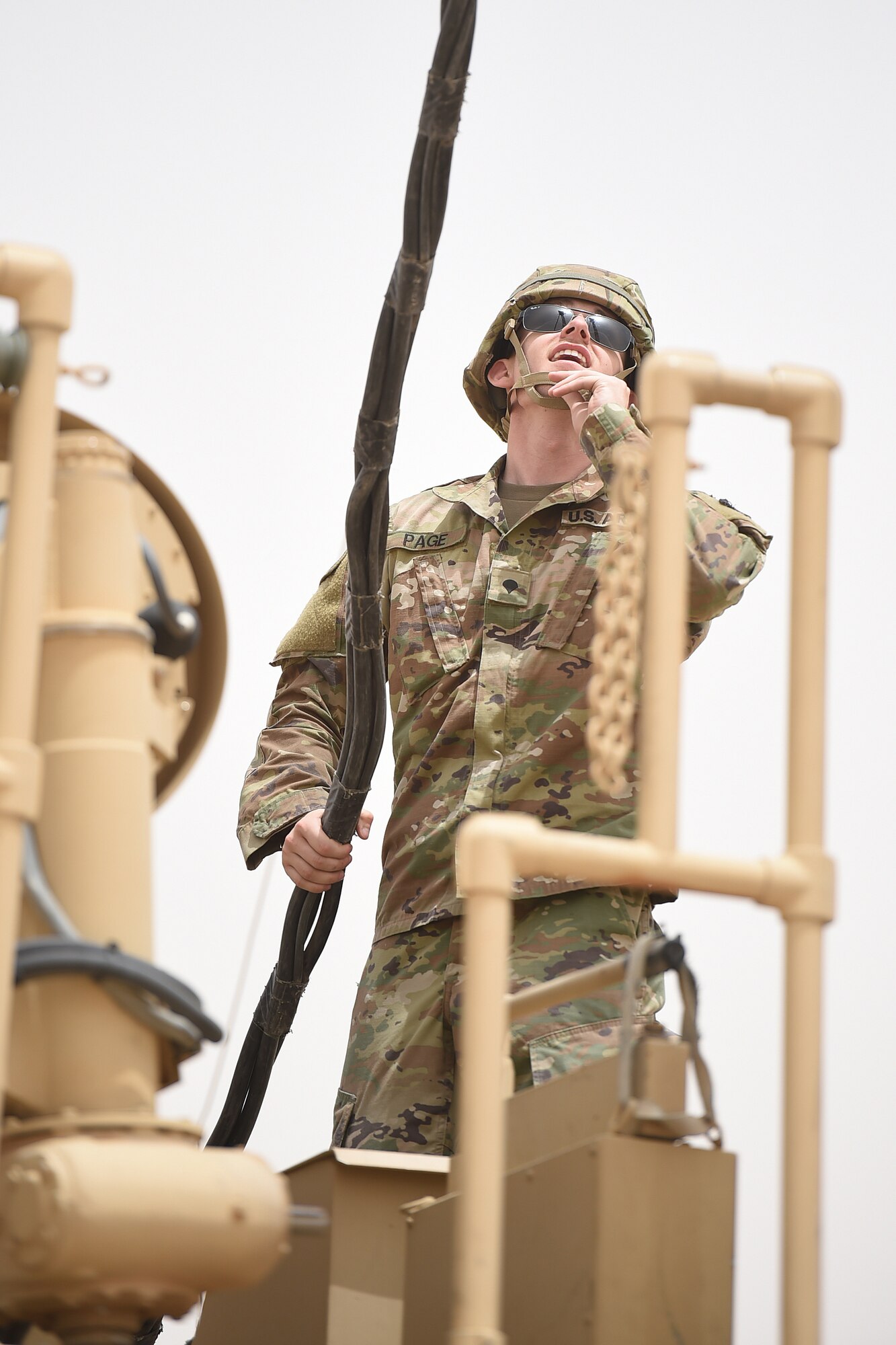 U.S. Army soldier stands on top of a large truck