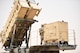 U.S. Army soldier stands on top of a large truck