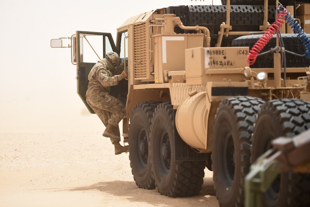 soldier jumps in to large truck