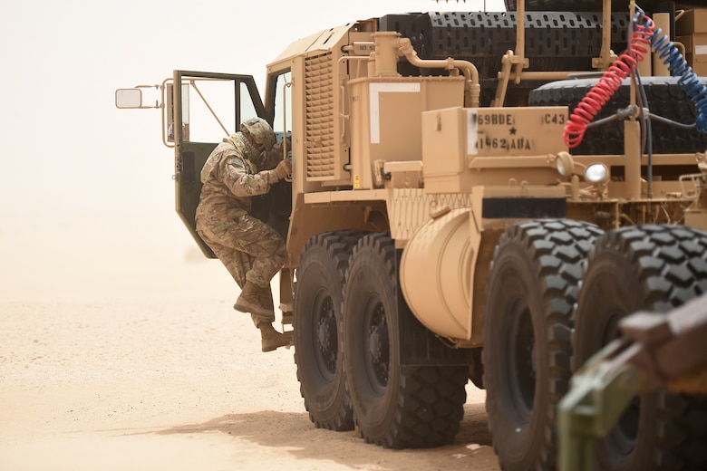soldier jumps in to large truck
