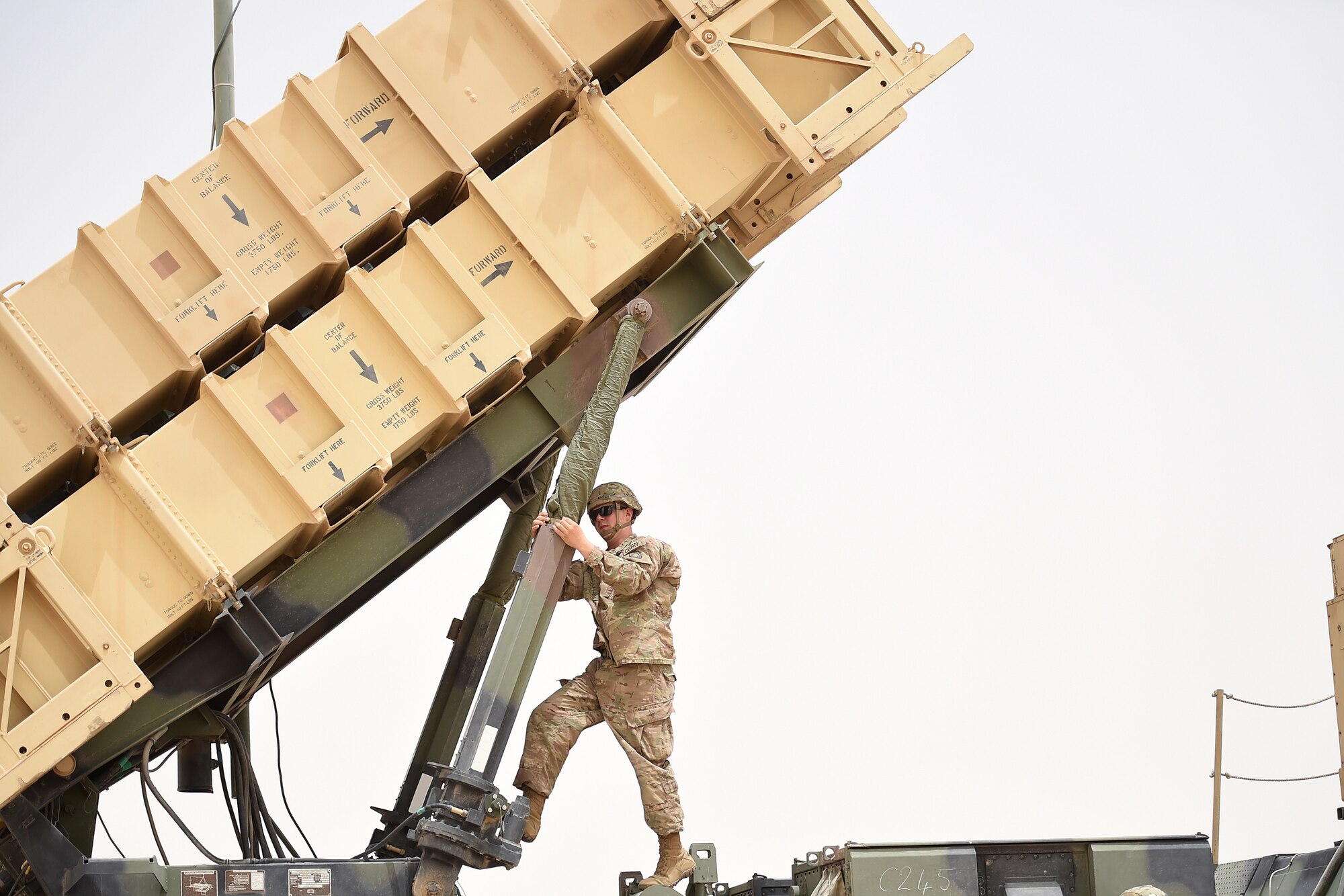 Soldier stands on top of large trcuk