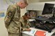 U.S. Air Force Senior Airman Joshua Glazier, U.S. Air Force Central Command deliberate and crisis action planning and execution segment operator, and U.S. Air Force Staff Sgt. Eric Alvarez, AFCENT personnel operator, review pre-deployment checklists at Al Udeid Air Base, Qatar, June 12, 2018. Manpower, Personnel and Services Directorate (A1) recently reduced the length of pre-deployment checklists in order to reduce redundancy and give more time for Airmen to spend with their families. (Photo by U.S. Air Force Staff Sgt. Caitlin Conner)