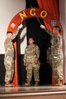 Soldier walking through arch