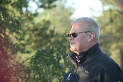 Lt. Col. (ret.) Ivars Sika, a former member of the Michigan National Guard, observes as members of the 82d Airborne Division stage a parachute drop at Ādaži Military Base, Latvia, June 9, 2018, as part of exercise Saber Strike 2018