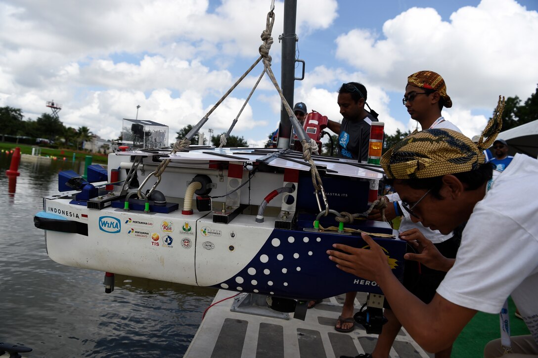 Students launch an autonomous boat during a competition.