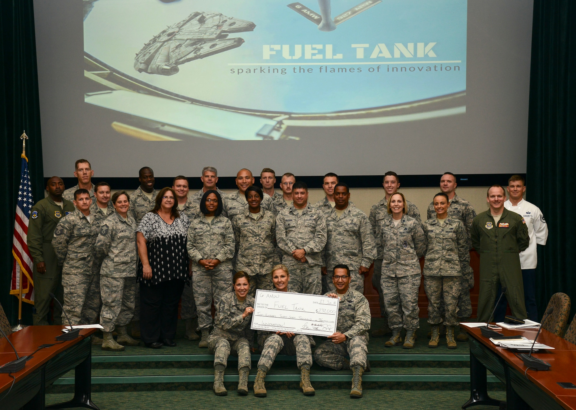 MacDill Fuel Tank presenters, judges and coordinators pause for a group photo after awarding $237,000 to ten innovative ideas at MacDill Air Force Base, Fla., June, 27, 2018.