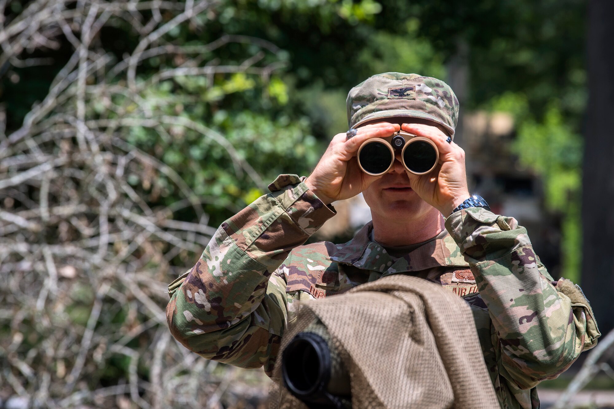 Col. Paul Birch, 93d Air Ground Operations Wing (AGOW) commander, looks through binoculars during an immersion tour, June 25, 2018, at Moody Air Force Base, Ga. Birch toured the 820th Base Defense Group to gain a better understanding of their overall mission, duties and comprehensive capabilities. Prior to taking command of the 93d AGOW, Birch was the commander of the 380th Expeditionary Operations Group at Al Dhafra Air Base, United Arab Emirates. (U.S. Air Force photo by Airman 1st Class Eugene Oliver)