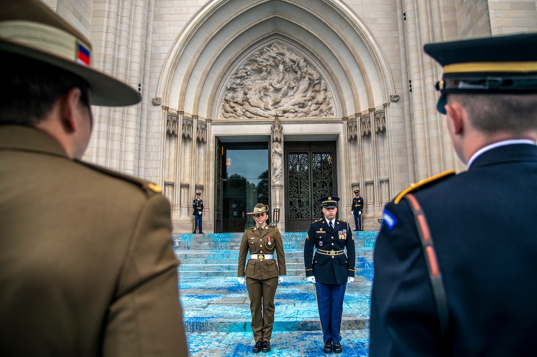 U.S. and Australian service members stand next to each other.