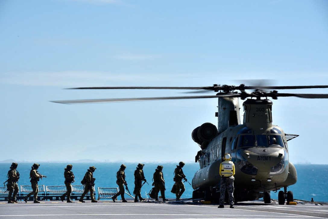 Members of the Australian Defence Force board a CH-53 helicopter during Exercise Sea Explorer aboard the HMAS Canberra at Sea June 9, 2018. The helicopters and soldiers were practicing rescue and recovery missions as part of the overall Ex Sea Series 18. The series is designed to train Australian Forces and get them amphibious ready. U.S. Marines and Sailors with Marine Rotational Force - Darwin 18 are working along side the ADF as part of the Amphibious Task Group.