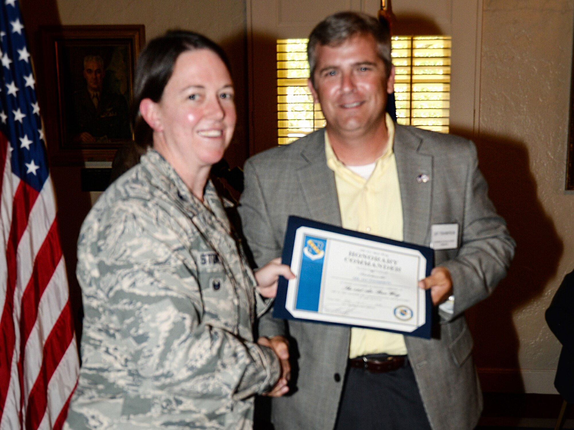 Colonel Melissa Stone, vice commander of the 42nd Air Base Wing, Maxwell Air Force Base, Alabama, congratulates her Honorary Commander, Jay Thompson, chairman of the Autauga, Alabama, County Commission, during the Honorary Commander Induction Ceremony at the Maxwell Club, June 19, 2018. (Air Force photo by Tech. Sgt. Patrick Brown)