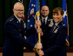 Maj. Gen. Chris Weggeman (left), Air Forces Cyber commander, presents the 67th Cyberspace Wing guidon to Col. Melissa Cunningham (right), 67th CW commander, during the wing’s change of command ceremony at Joint Base San Antonio-Lackland June 20. Col. Bradley Pyburn relinquished command of the wing to Cunningham.
