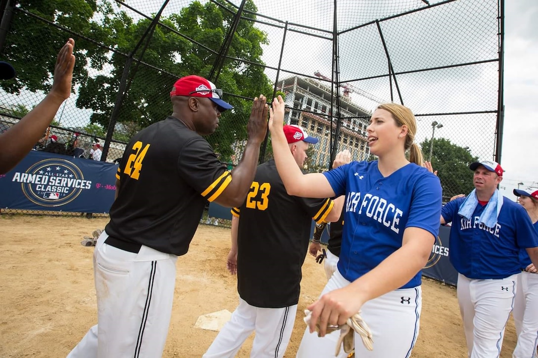 AFOSI's Staff Sgt. Bobbi Robinson, JBAB, Md., high fives an Army player after the Air Force edged the Soldiers 16-15, on their way to a berth in the inaugural All-Star Armed Services Classic Tournament Championship at Washington Nationals Park, July 13, 2018. The title game will be the first major ballpark event of MLB's All-Star Week. (Photo by Cory Royster)