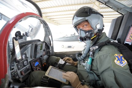 Tony Ervin, 502nd Air Base Wing, Public Affairs illustrator, prepares to test the electronic flight bag during flight, June 21, at Joint Base San Antonio-Randolph.  EFBs are used by aircrews to plan, execute and debrief flights. Applications on the tablets enable pilots and their crews to determine weather patterns, approach paths, flight line makeup and other relevant information used during all types of flying missions.  (U.S. Air Force photo by Joel Martinez)