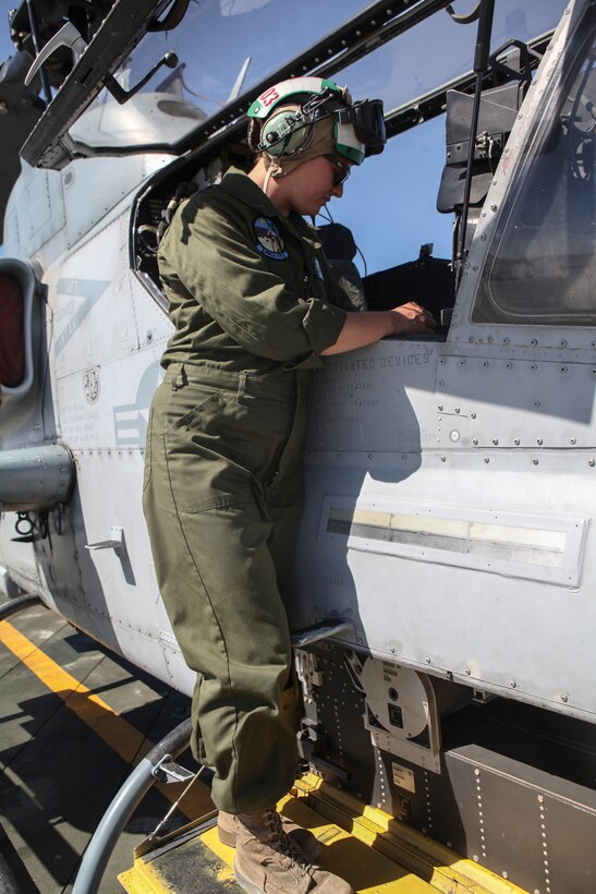 Sgt. Catherine J. Salvador, an avionics technician with Marine Light Attack Helicopter Squadron 775, Marine Aircraft Group 41, 4th Marine Aircraft Wing, examines an AH-1W Super Cobra during Integrated Training Exercise 4-18 at Marine Corps Air Ground Combat Center Twentynine Palms, California, on June 22, 2018. In 2018, Salvador participated in ITX 4-18 for her first time as a Reserve Marine. (United States Marine Corps photo by Cpl. Alexis B. Rocha/released)
