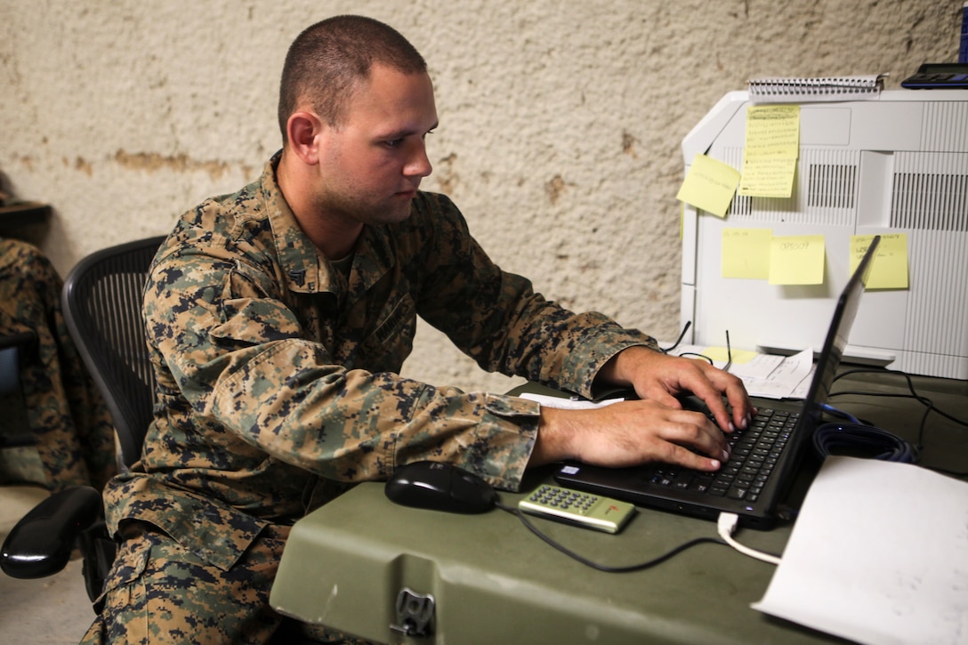 Cpl. Alex T. Ruppert, an ammunition technician with Supply Company, Combat Logistics Battalion 451, Combat Logistics Regiment 45, 4th Marine Logistics Group, based in Greenville, South Carolina, works at his computer during Integrated Training Exercise 4-18 at Marine Corps Air Ground Combat Center Twentynine Palms, California, on June 25, 2018. During ITX 4-18, Ruppert served as the records chief for the field ammunition supply point, which is used for storage and distribution of ammunition for training. (United States Marine Corps photo by Cpl. Alexis B. Rocha/released)