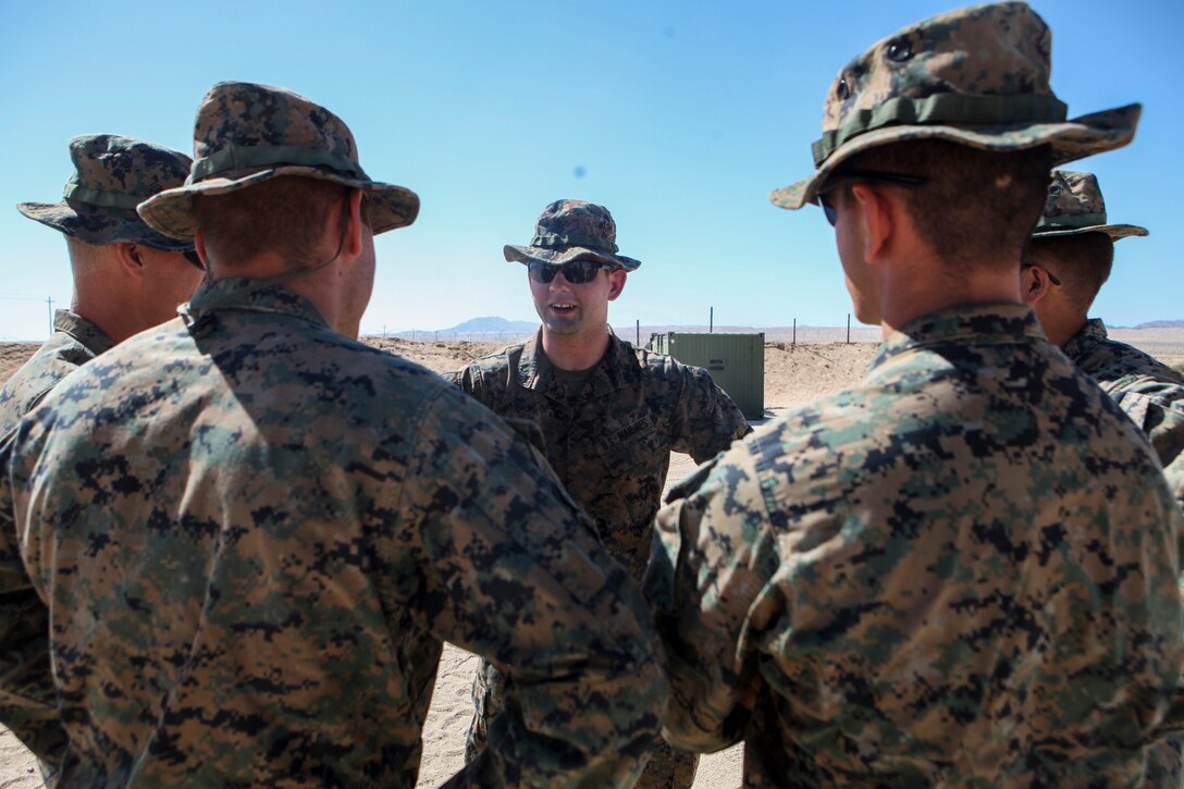 Cpl. Alex T. Ruppert, an ammunition technician with Supply Company, Combat Logistics Battalion 451, Combat Logistics Regiment 45, 4th Marine Logistics Group, based in Greenville, South Carolina, talks to his junior Marines at Integrated Training Exercise 4-18 at Marine Corps Air Ground Combat Center Twentynine Palms, California, on June 25, 2018. During ITX 4-18, Ruppert served as the records chief for the field ammunition supply point, which is used for storage and distribution of ammunition for training. (United States Marine Corps photo by Cpl. Alexis B. Rocha/released)