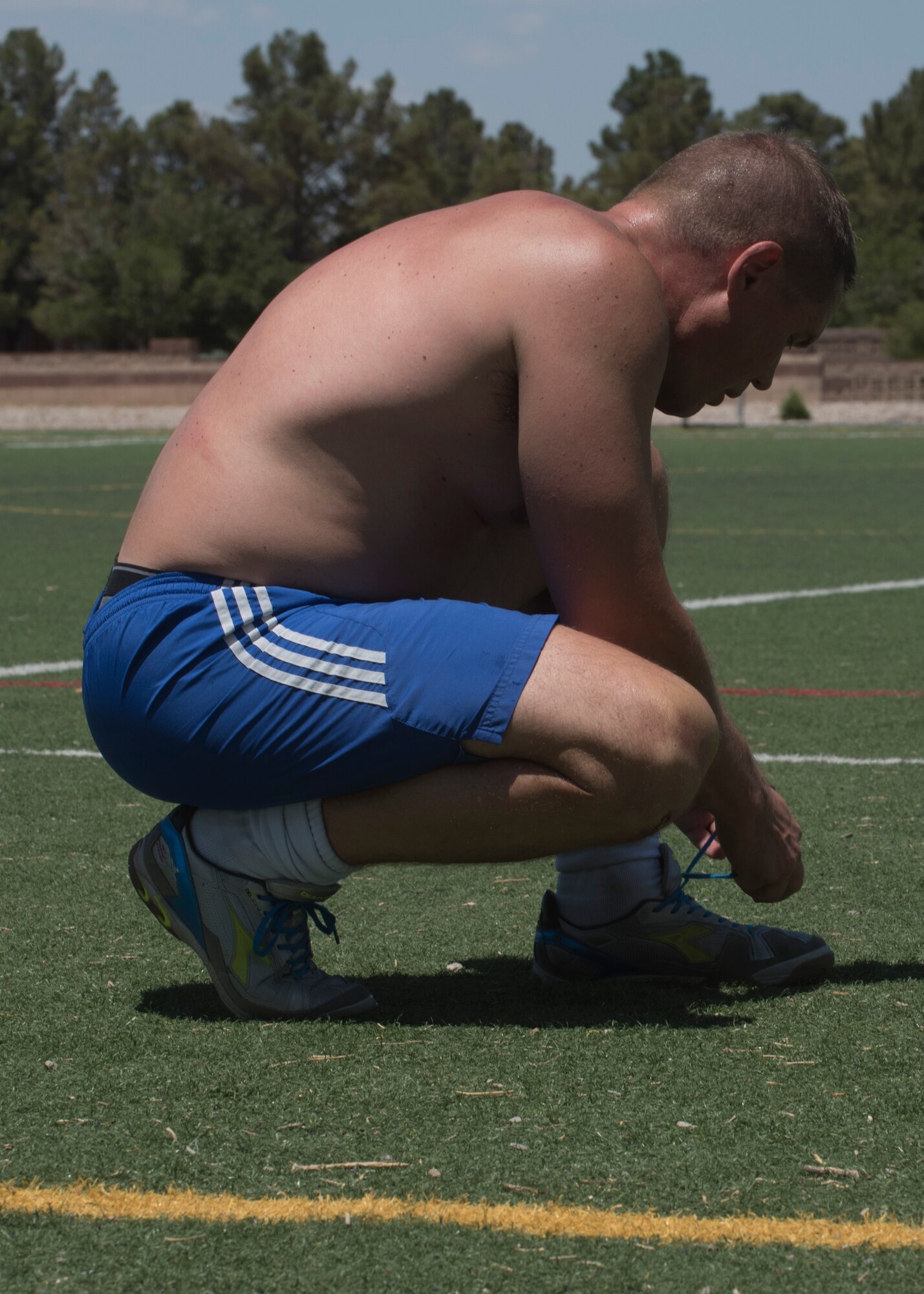 Col. Paul Brezinski, Holloman’s Varsity Soccer coach, ties his shoe laces at the base soccer field June 10. Brezinski has been playing soccer almost all his life, and dealing with Parkinson’s Disease for 8 years. (U.S. Air Force photo by Airman Autumn Vogt)