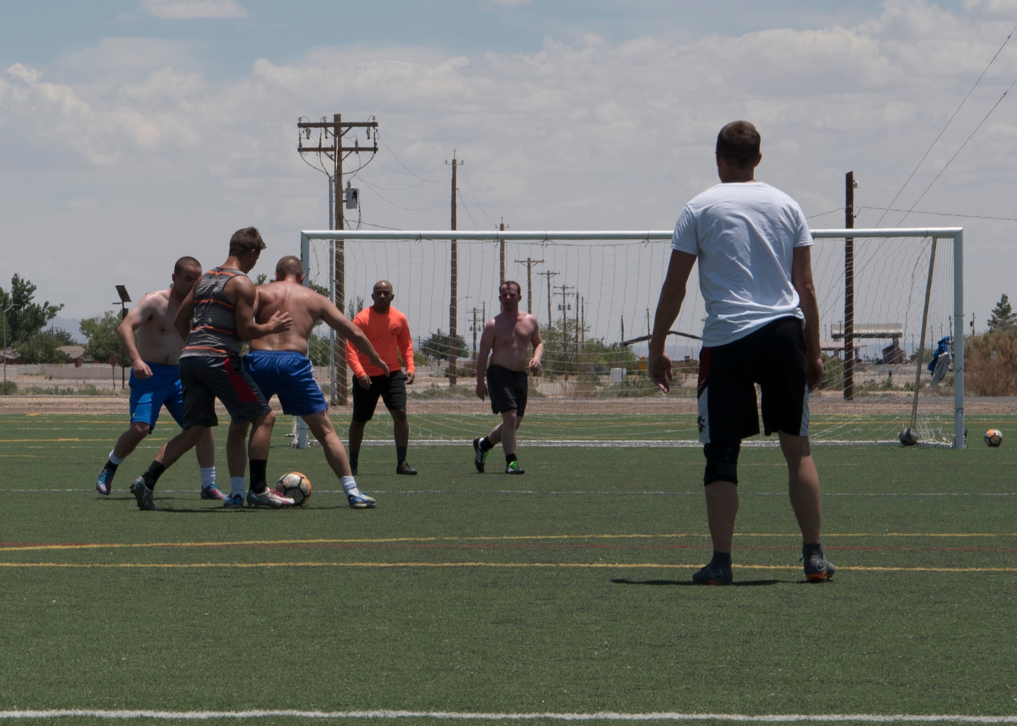 The Holloman Air Force Base Varsity Soccer team moves the goal to have a half-field practice June 10 at the base soccer field. It was Col. Paul Brezinski’s last practice before his brain surgery June 13 and 15 for Parkinson’s Disease. (U.S. Air Force Photo by Airman Autumn Vogt)