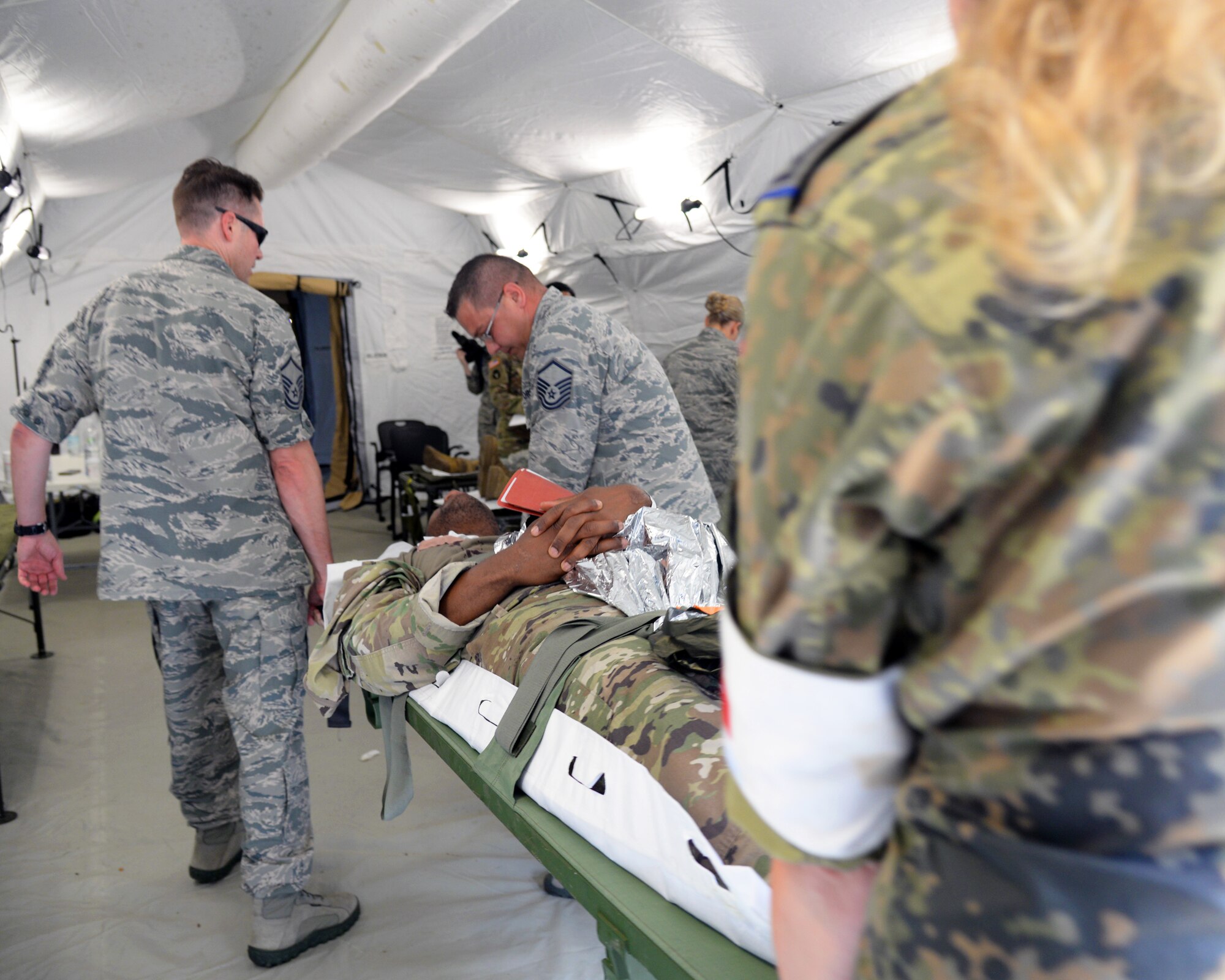 Airmen from the 86th Medical Group conducted Ability to Survive and Operate training in an Expeditionary Medical Support System modular field hospital during en route patient staging training during Exercise Maroon Surge on Ramstein Air Base, Germany, June 9, 2018. ATSO training is designed to improve Airmen’s performance during stressful circumstances. (U.S. Air Force photo by Airman 1st Class Ariel Leighty)