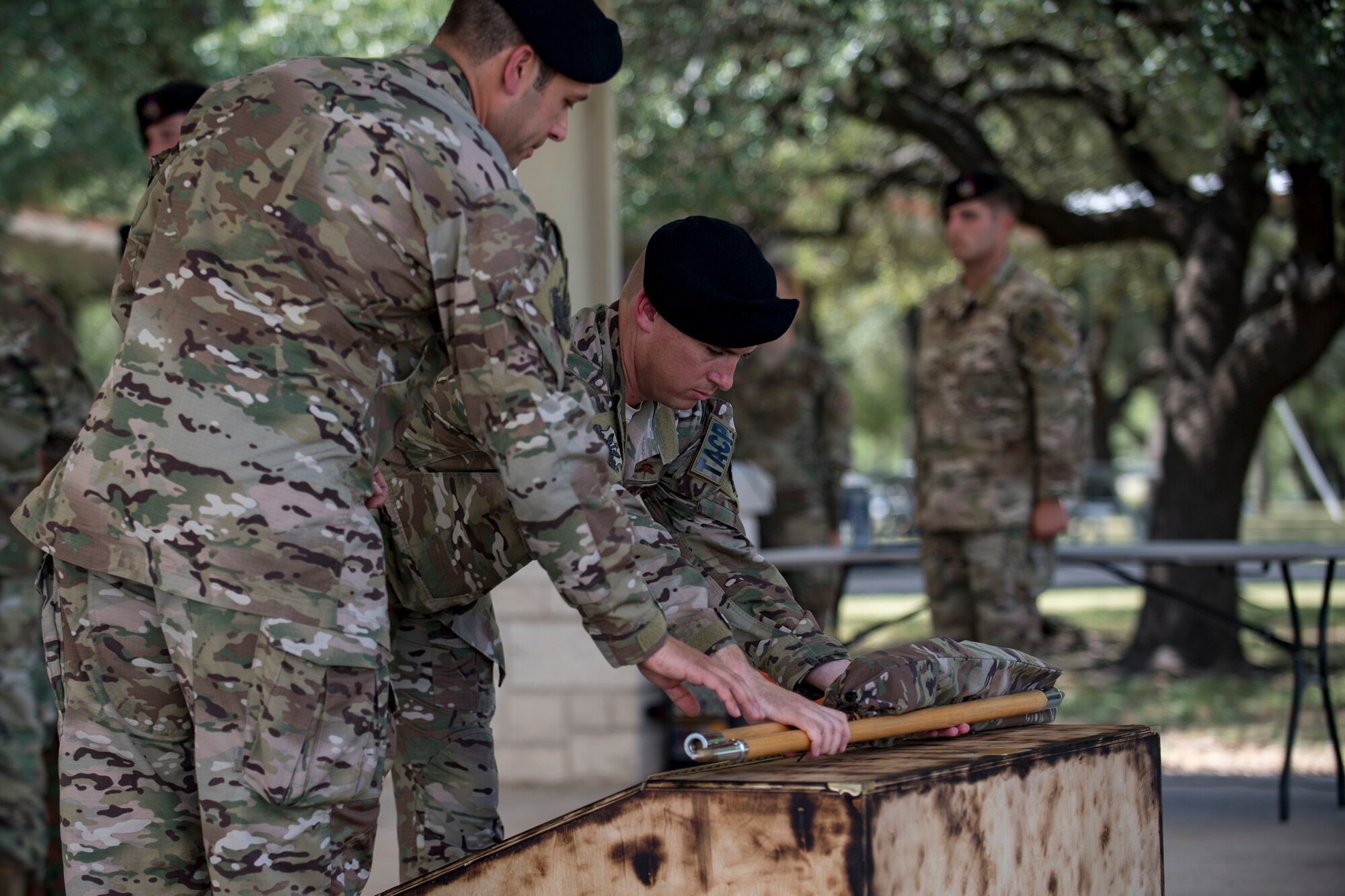 Lt. Col. Frank Biancardi, outgoing 11th Air Support Operations Squadron (ASOS) commander, and Master Sgt. Daniel Nestor, 11th ASOS superintendent, place an unassembled guidon to rest during a squadron inactivation ceremony, June 21, 2018, at Fort Hood, Texas. As a part of the 93d Air Ground Operations Wing from Moody Air Force Base, Ga., the 11th ASOS ‘Steel Eagles’ mission will remain unchanged as they continue to support Ft. Hood and absorb into the 9th ASOS. The enhanced 9th ASOS will continue to provide tactical air support to align with any U.S. Army unit that needs air support for their scheme of maneuver. (U.S. Air Force photo by Senior Airman Daniel Snider)