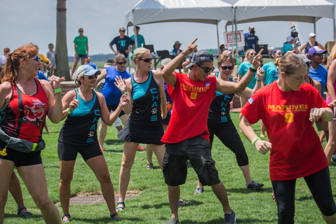 Sgt. David Moncada, with Marine Air Control Squadron II, leads line dancing during the annual DragonBoat Beaufort charity race June 23 at the Waterfront Park in downtown Beaufort. The event is held to raise money for local cancer patients, survivors and their families. Marines, Sailors, friends, and families from Marine Corps Air Station Beaufort, Marine Corps Recruit Depot Parris Island, and Naval Hospital Beaufort competed in and volunteered at the event.
