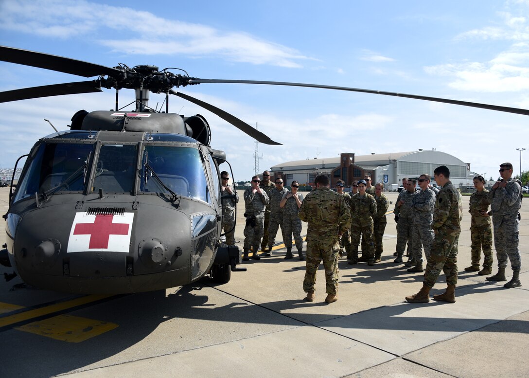 Members of the Pittsburgh International Airport Air Reserve Station Aeromedical Staging Squadron and Aeromedical Evacuation Squadron receive training on how to load a patient onto a helicopter at the Pittsburgh International Airport Air Reserve Station, Pennsylvania, June 26, 2018. This was part of their joint training and was something these medical squadrons do not get to do often.(U.S. Air Force Photo by Senior Airman Grace Thomson)