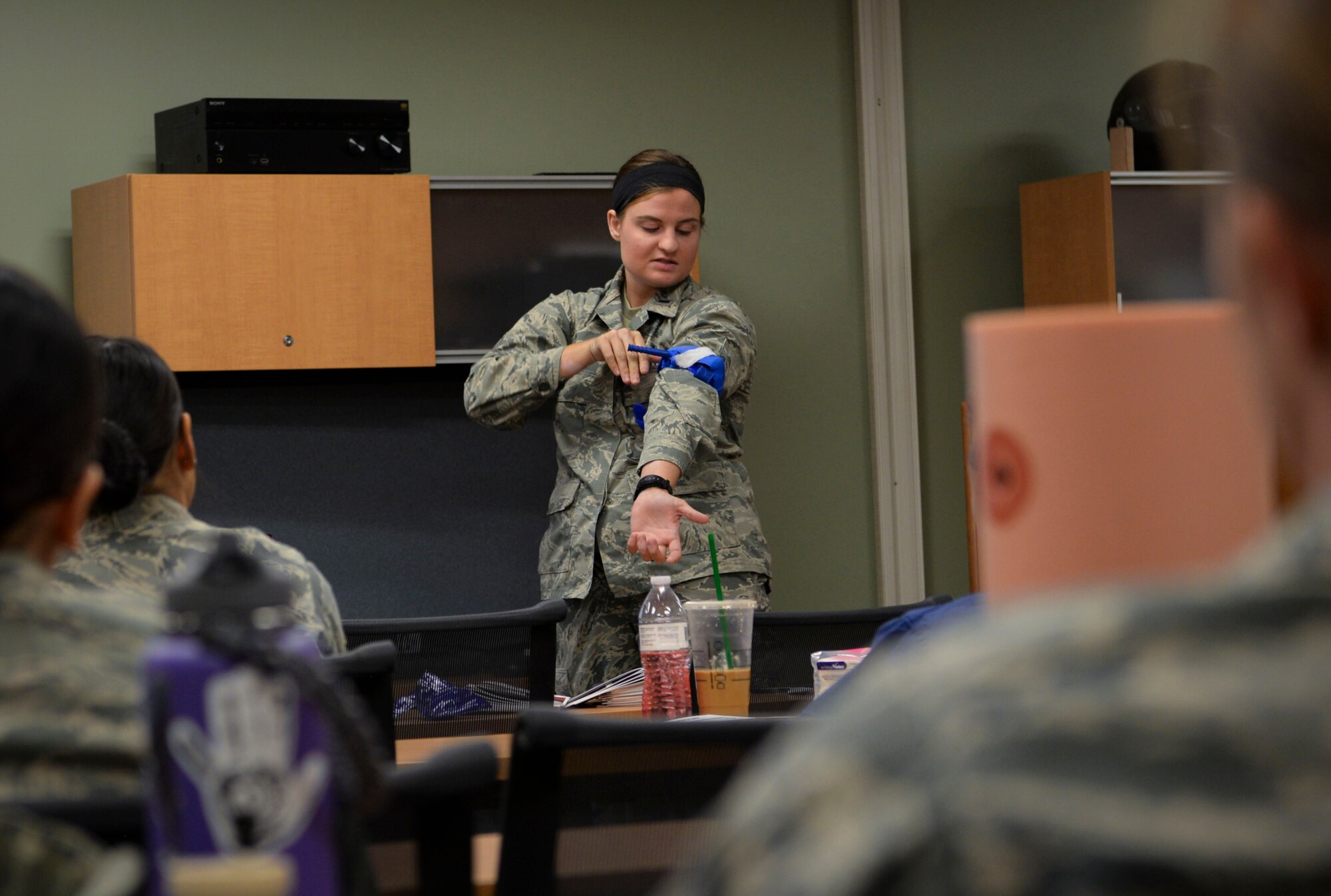 1st Lt. Caitlin Totman, 99th Inpatient Operations Squadron registered nurse, demonstrates how to properly use a tourniquet at Mike O’Callaghan Military Medical Center on Nellis Air Force Base, Nevada, June 22, 2018. The course stresses the mechanisms of the body and how bleeding can be drastically decreased by focusing on the three main methods of hemorrhage control: compression, tourniquet use and wound packing. (U.S. Air Force Photo by Airman Bailee A. Darbasie)