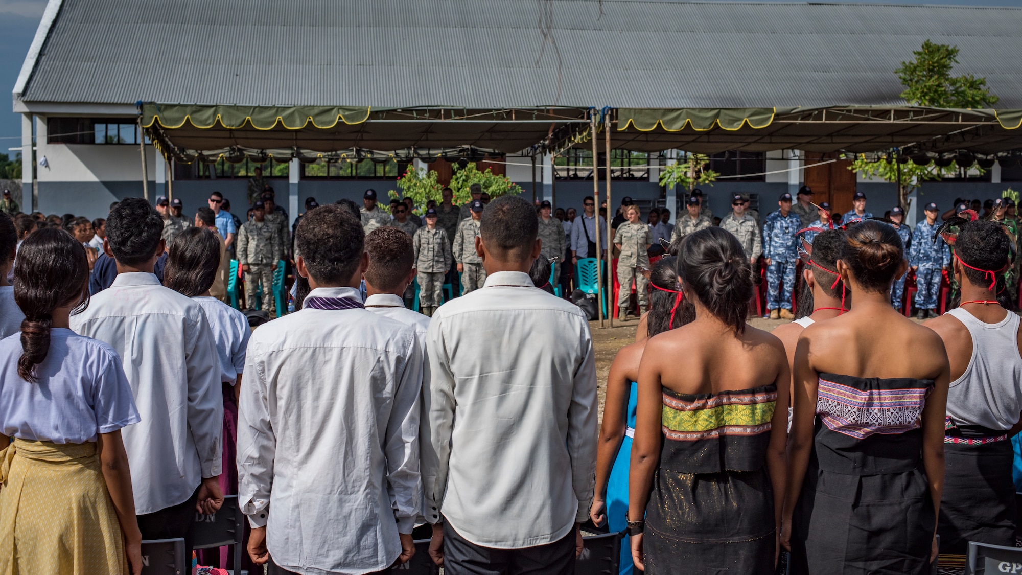 Timor-Leste students stand for the playing of their country’s national anthem during the closing ceremonies for Pacific Angel (PAC ANGEL) 2018 at the Negri Saran Kote Secondary School in Suai, Cova Lima Municipality, Southwest Timor-Leste, June 18, 2018.