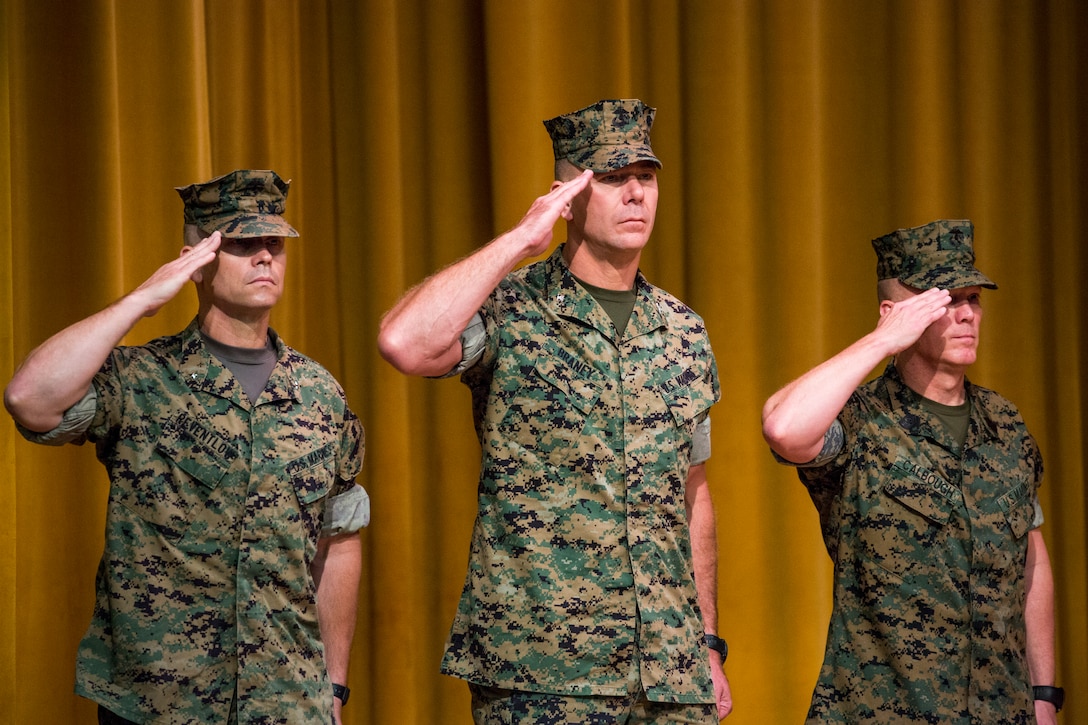 Brig. Gen. Keith D. Reventlow, left, Col. Ronald C. Braney, right, and Sgt. Maj. James N. Calbough, left, honor the nation's colors during a transfer of command ceremony June 29, 2018 at Camp Foster, Okinawa Japan. Reventlow, a native of Newtown, Conneticut, assumed command as the commanding general of 3rd Marine Logistics Group. (U.S. Marine Corps photo by Cpl. Joshua Pinkney)