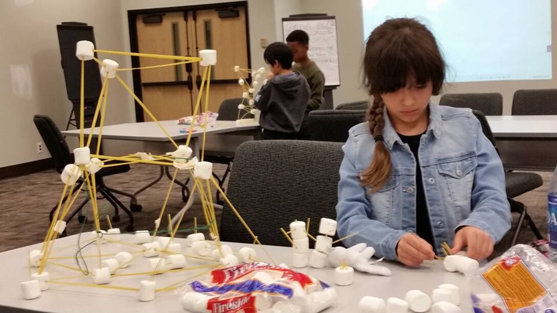 Felicity Maynor building her spaghetti and marshmallow tower