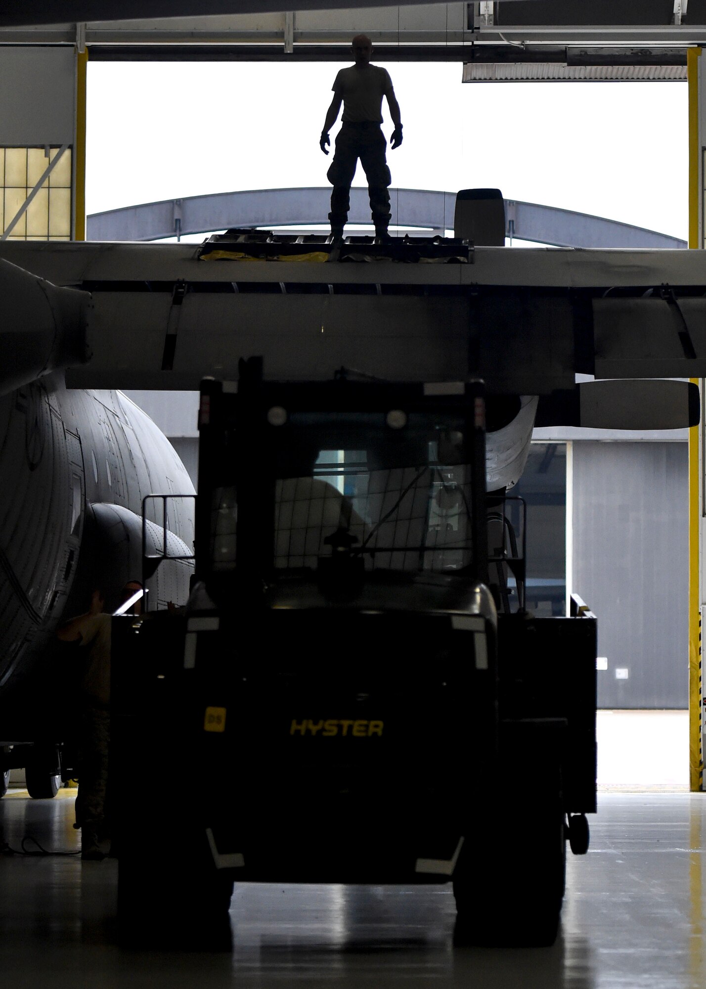 Reserve Citizen Airman Master Sgt. Dan Scott, aircraft maintenance craftsman with the 910th Aircraft Maintenance Squadron, directs a forklift into place by the wing of a C-130H Hercules aircraft here, June 13, 2018.
