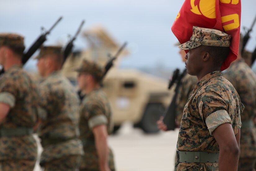 U.S. Marine Corps Sgt. Rasheed Whittle, platoon guide with Marine Wing Support Squadron 472, Marine Aircraft Group-49, 4th Marine Aircraft Group, marches with the platoon on Joint Base McGuire-Dix-Lakehurst, N.J., June 22, 2018. The Marine appointed to be guide has the honor of carrying their units’ guidon. (U.S. Marine Corps photo by Cpl. David A. Torres)